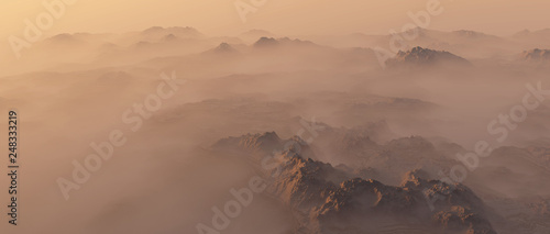 Mountain range in mist at sunrise.