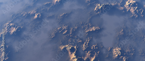 Aerial of rough rocky terrain in mist.