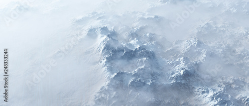 Aerial of rough steep snowy mountains in fog. © ysbrandcosijn