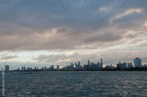 Wide angle evening scene of skyscrapers horizon with ocean and tall office and residential towers in Melbourne Australia