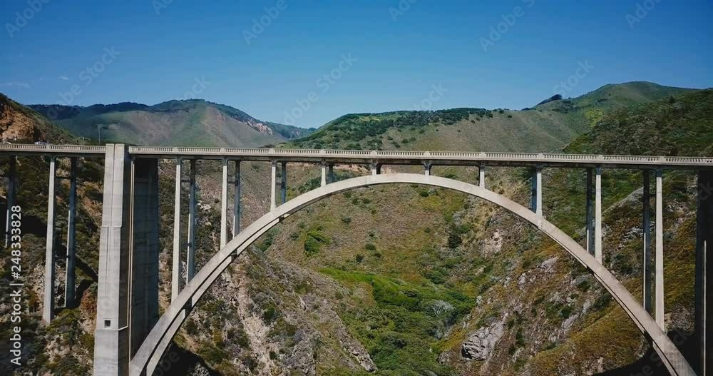 Drone is flying right under iconic famous Bixby Creek Bridge at Highway 1, famous American travel destination in Big Sur Drone is flying right under iconic famous Bixby Creek Bridge at Highway 1, famous American travel destination in Big Sur