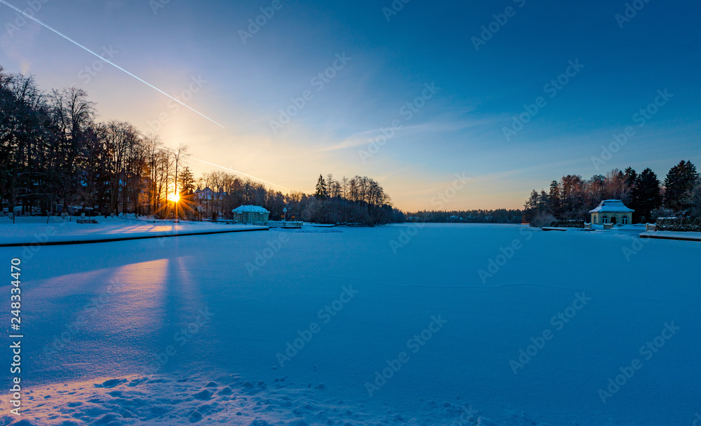 Winter sunrise over a snow-covered lake