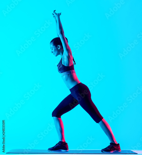 one mixed races woman exercsing stretching fitness exercices isolated on blue blackground photo