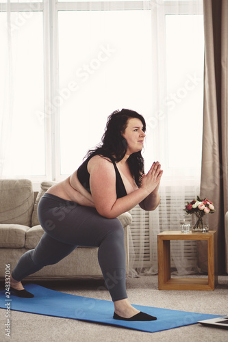 flexibility, grace, good mood, healthy lifestyle,vitality. yoga workout for women. overweight woman stretching during home training
