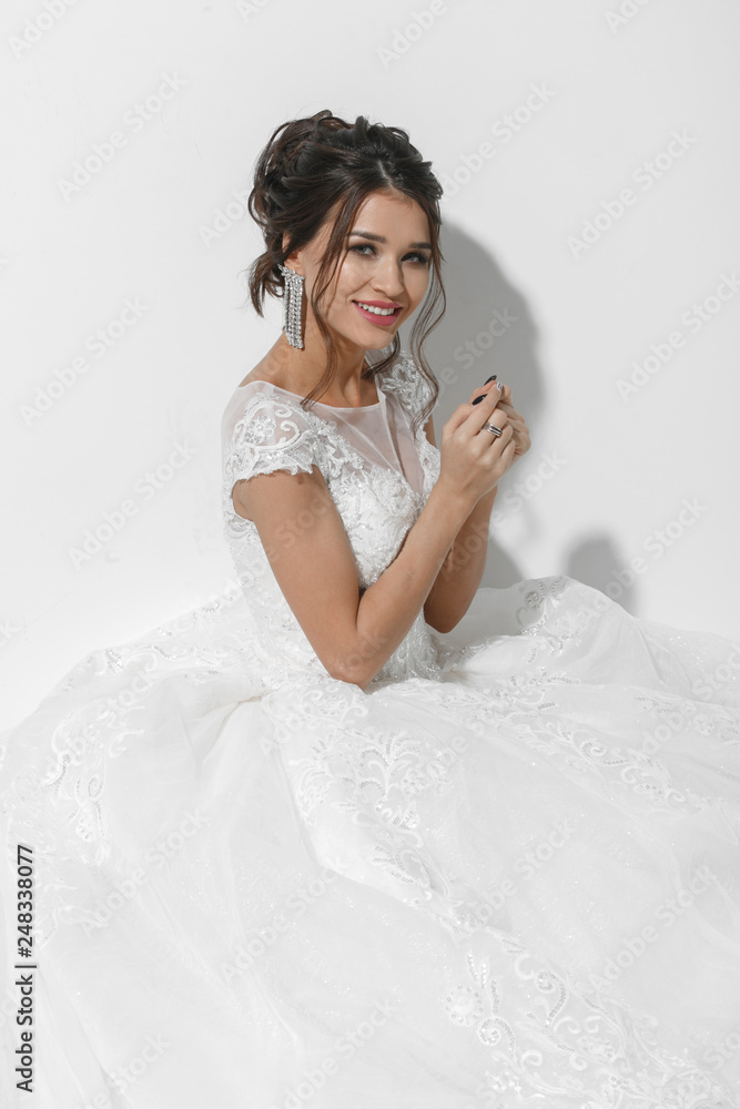 Beautiful young bride in white studio Beautiful young bride in white studio