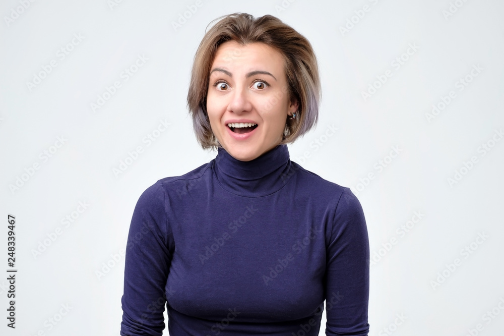 Surprised young woman in blue clothes shouting shocked with great news. Surprised young woman in blue clothes shouting shocked with great news.