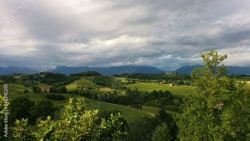 prosecco wine hill district around susegana, green and smooth hill with cloudy sky