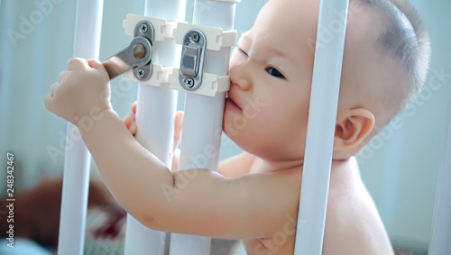 A toddler boy trying to unlock the door and escape