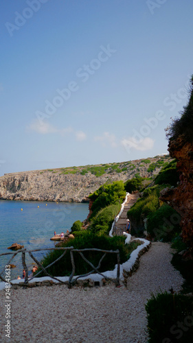 Beautifull view of Cala Morell cove, red rocks and clear blue water, Menorca island, Balearic Islands, Spain.