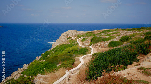 Beautifull view of Cala Morell cove, red rocks and clear blue water, Menorca island, Balearic Islands, Spain.