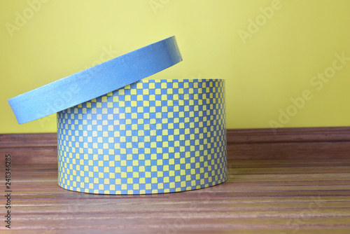 decorative hatbox whith open lid on wooden floor photo