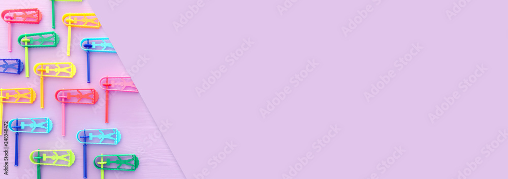 top view image of Purim celebration concept (jewish carnival holiday) over purple background. Top view, flat lay. top view image of Purim celebration concept (jewish carnival holiday) over purple background. Top view, flat lay.