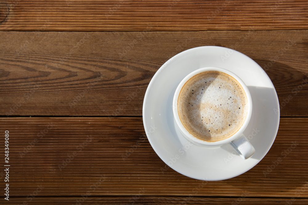 Coffee cup top view on wooden table background. Beautiful morning, outdiir, spring sun light. Coffee cup top view on wooden table background. Beautiful morning, outdiir, spring sun light.