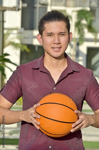 Athletic Filipino Male Basketball Player Smiling With Basketball © dtiberio