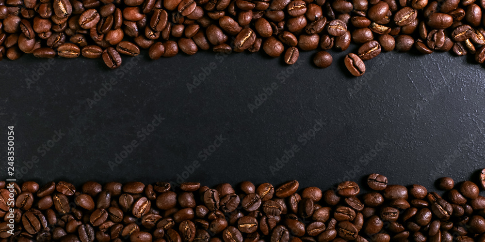 Aroma roasted coffee beans on rustic tabletop, brown banner background.