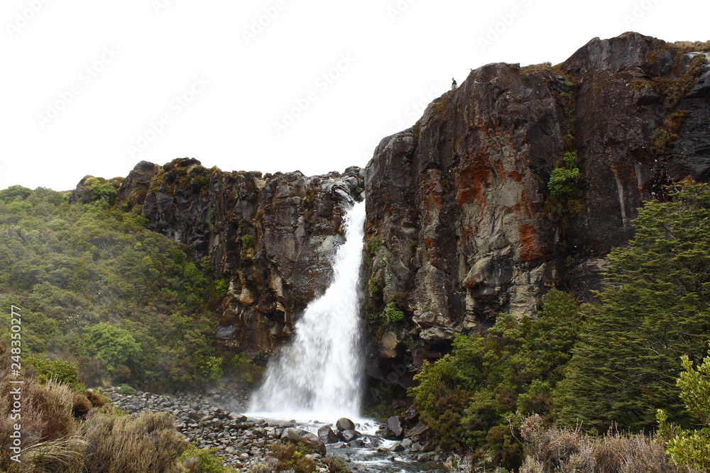 Taranaki Falls, Tongariro National Park, New Zealand, North island with trekking man above