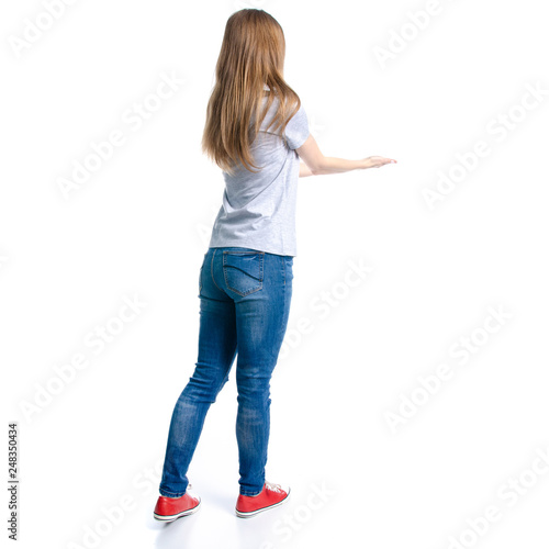 Woman in jeans t-shirt showing holding on white background isolation, back view