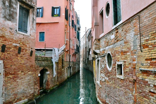 Classic Venice channel view with typical buildings, colorful windows, bridges and boats © DoubleM