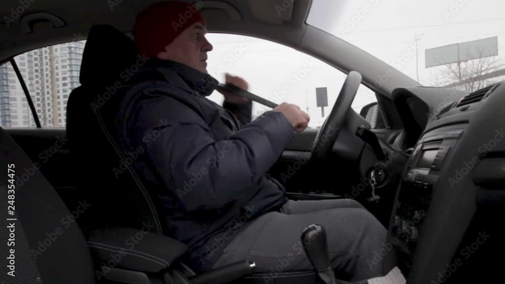 Male Driver Fastening Seat Belt In Car Male Driver Fastening Seat Belt In Car