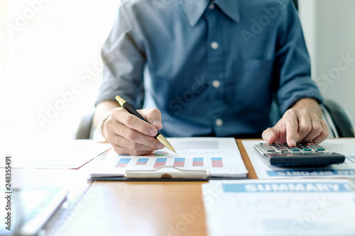 Business man using calculator working at office with reports document financial.