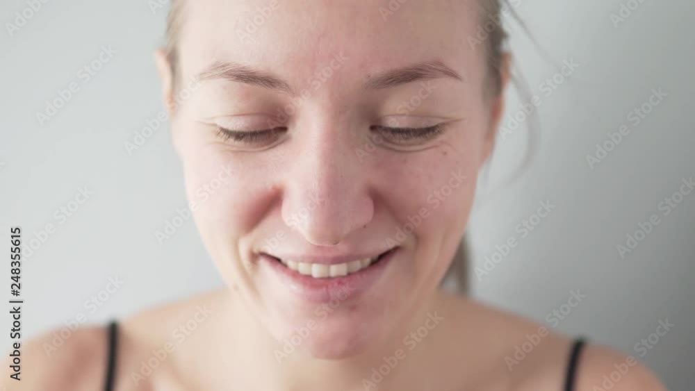 Beautiful young woman doing skin care around the eyes. She puts silicone patches on her eyes. Close-up face, girl cute smiles. One patch comes off and starts to fall, this is ridiculous. Beautiful young woman doing skin care around the eyes. She puts silicone patches on her eyes. Close-up face, girl cute smiles. One patch comes off and starts to fall, this is ridiculous.