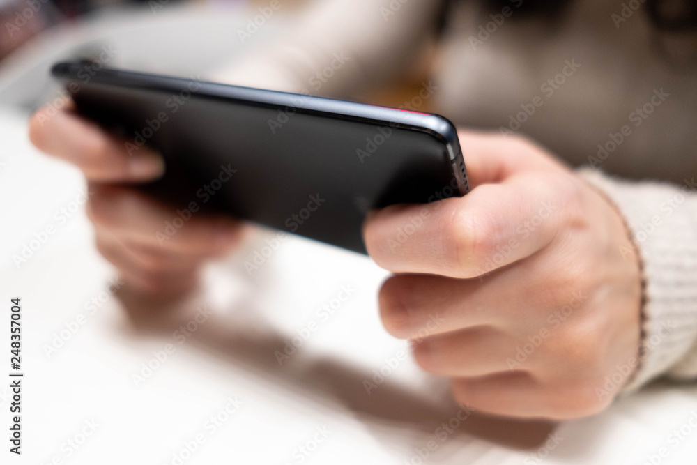Young female hans with black smarphone watching screen. Digital device addiction, social and education. Young female hans with black smarphone watching screen. Digital device addiction, social and education.