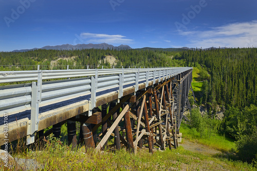 The Kuskulana Bridge over the Kuskulana River on McCarthy Road in the Wrangell Mountains. The Wrangell Mountains are a high mountain range of eastern Alaska, UNESCO World Heritage Site photo