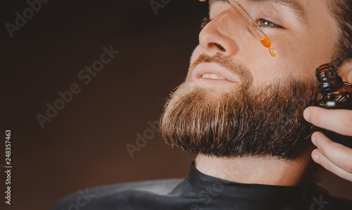 Obraz na plátně Oil for spa grooming and beard growth for man in a dropper