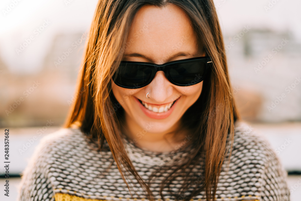 Young woman smiling with sunglasses Young woman smiling with sunglasses