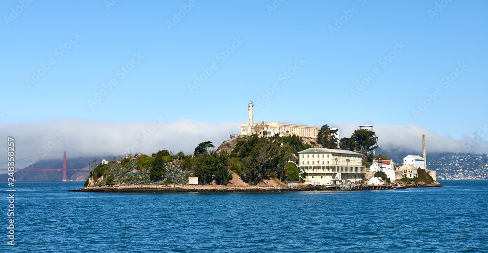 Panorama of Alcatraz Prison in the bay with the Golden Gate bridge in the background