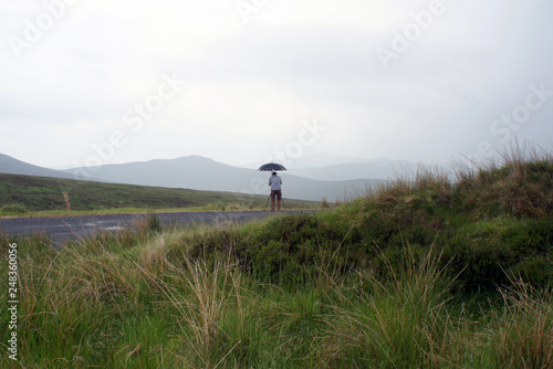 Umbrella, photographer and drizzle in the Wicklow Mountain.Ireland. 