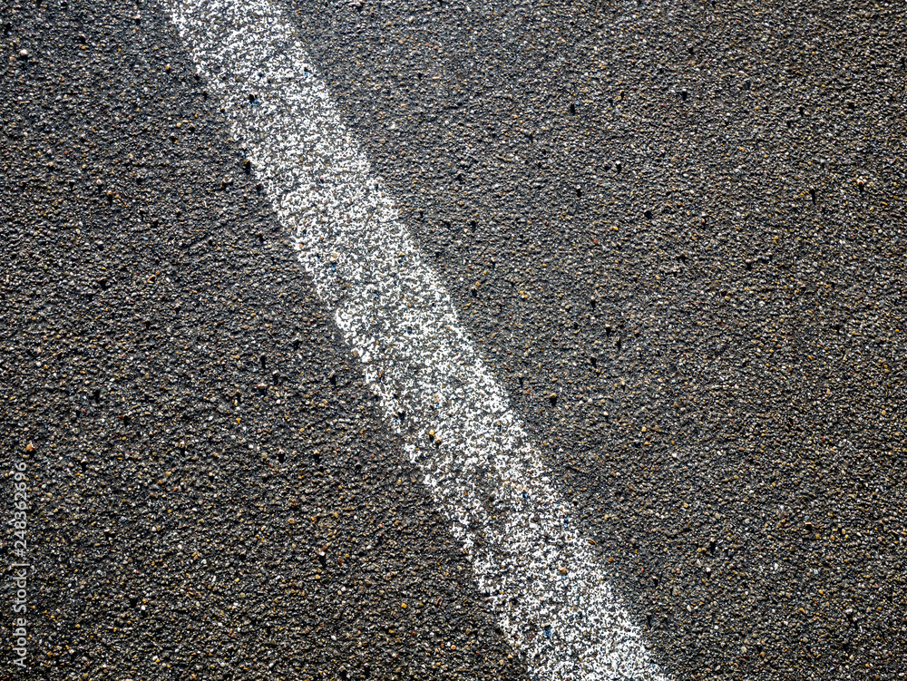 Fototapeta premium Image of white line on asphalt on street