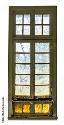 Large vintage window of an abandoned building  spooky forest can be seen behind the glass. Isolated on white