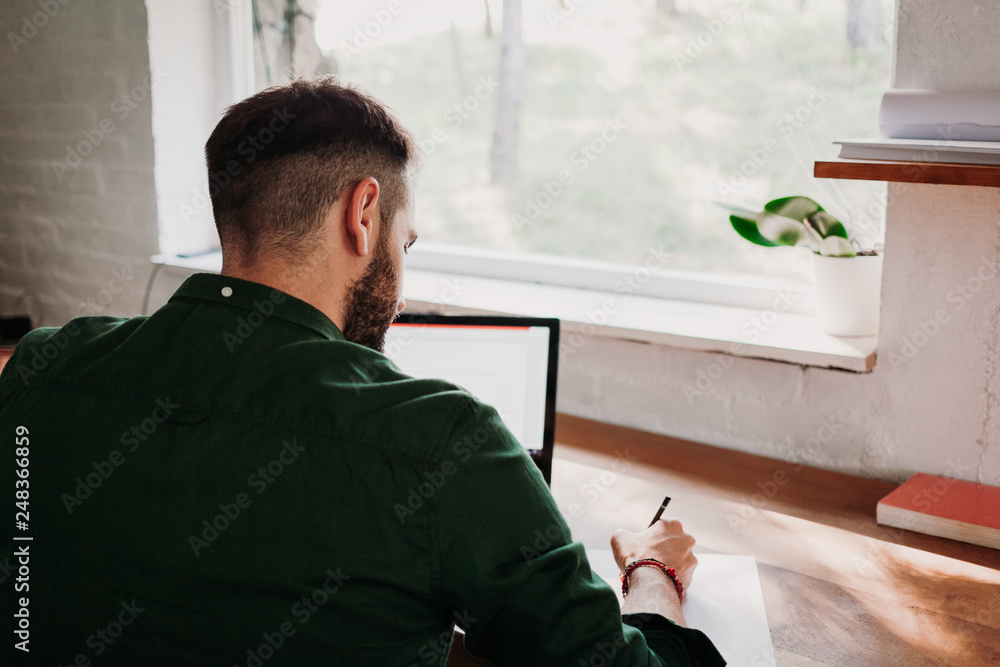 Young casual man working on a laptop Young casual man working on a laptop
