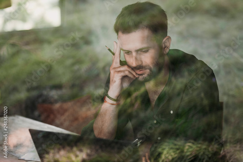 Young casual man working on a laptop