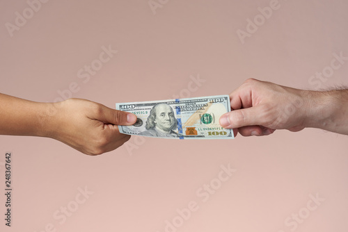 Hands holding dollar bill