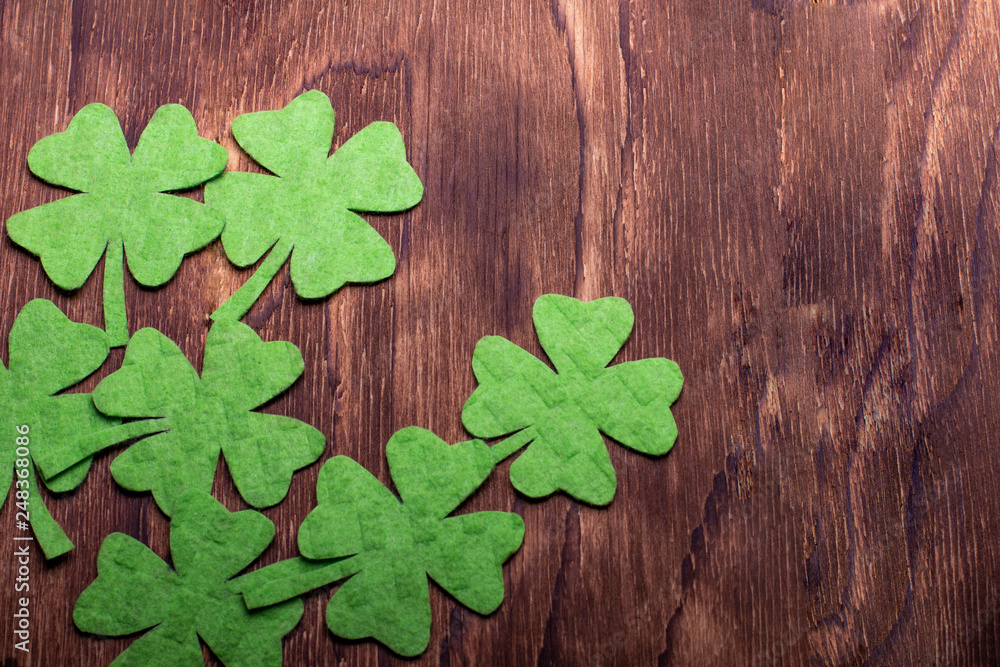 Green clover leaf on wooden background Green clover leaf on wooden background
