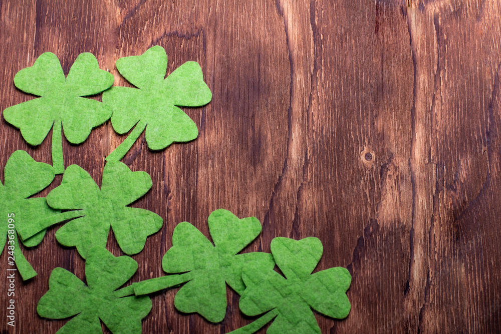 Green clover leaf on wooden background Green clover leaf on wooden background