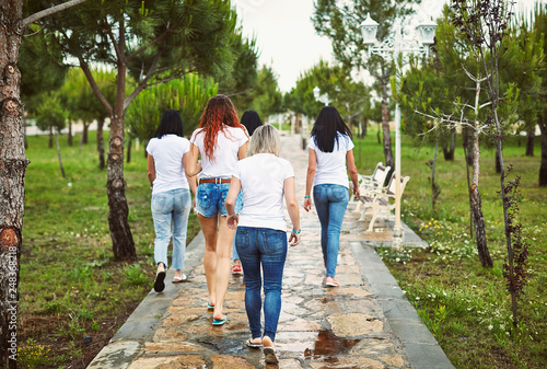 Group of friends women walking in park