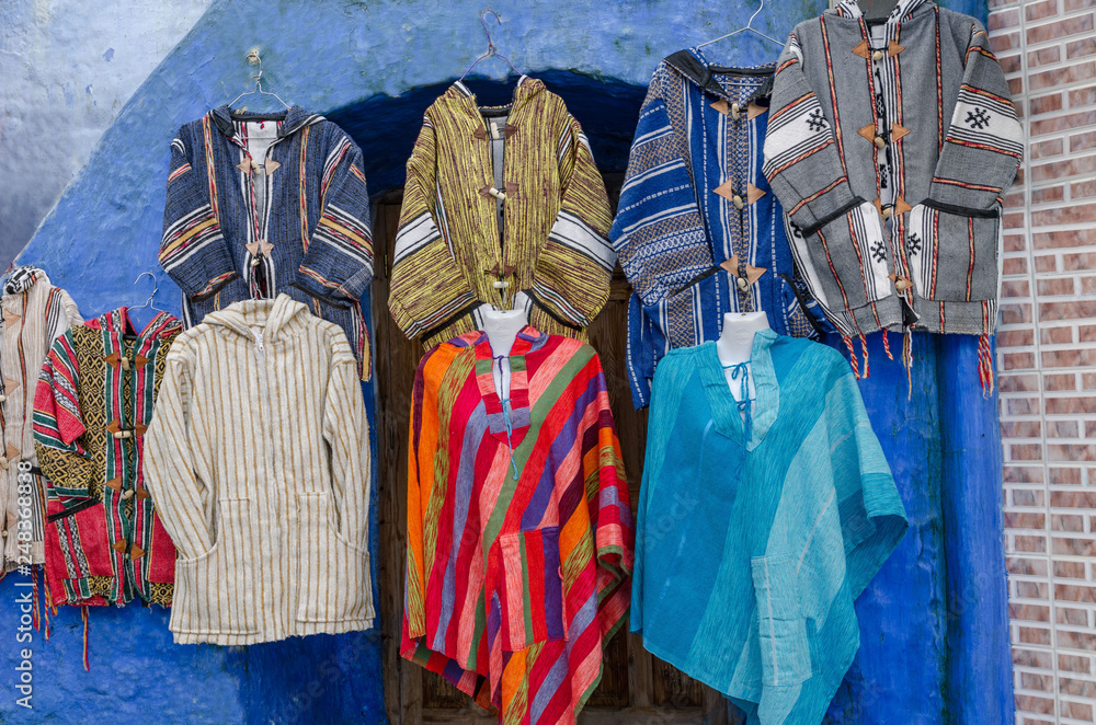 Amazing Morocco, blue city of Chefchaouen, narrow streets, blue walls, unusual clothes for sale