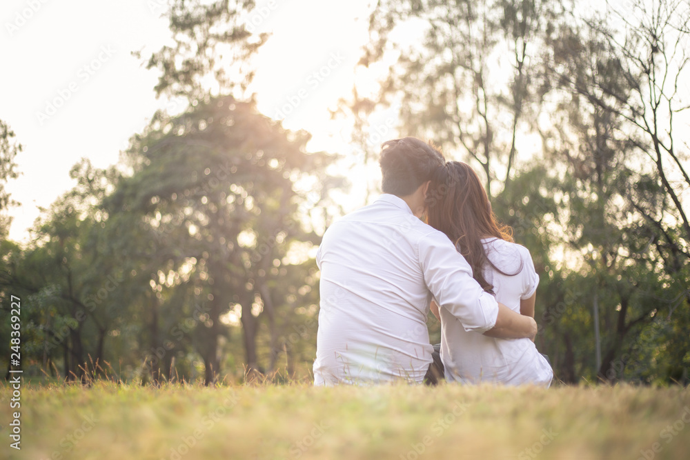 Young man hugging his girlfriend from behind while dating in the park Young man hugging his girlfriend from behind while dating in the park