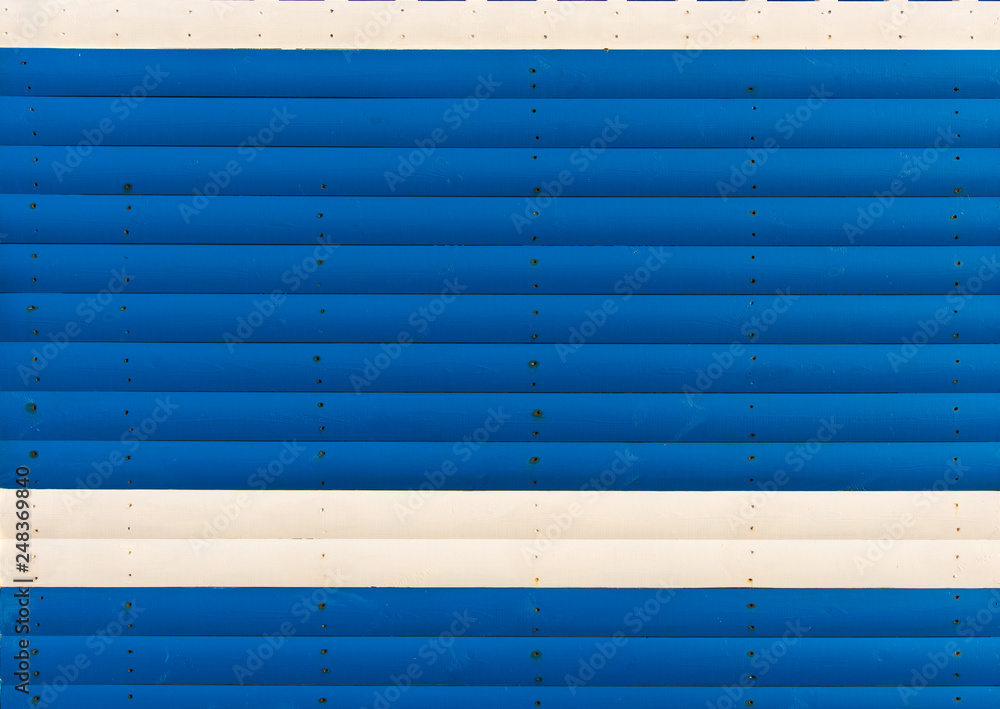Section of blue and white wood panelling from a seaside beach hut. Perfect as a background for Summer Holiday or seaside themes. Section of blue and white wood panelling from a seaside beach hut. Perfect as a background for Summer Holiday or seaside themes.
