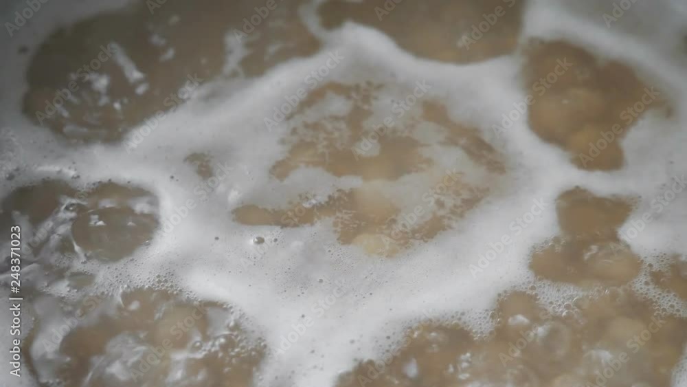 Boiling chickpeas in saucepan, closeup. Nobody Boiling chickpeas in saucepan, closeup. Nobody