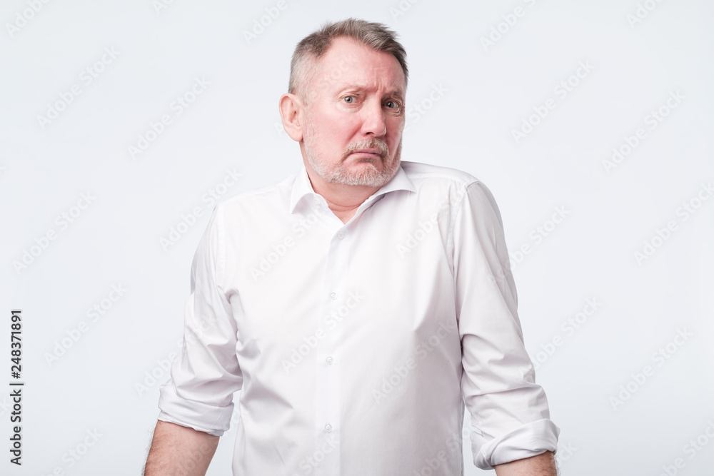 Uncertain upset pensive male hesitates what to buy. Uncertain upset pensive male hesitates what to buy.