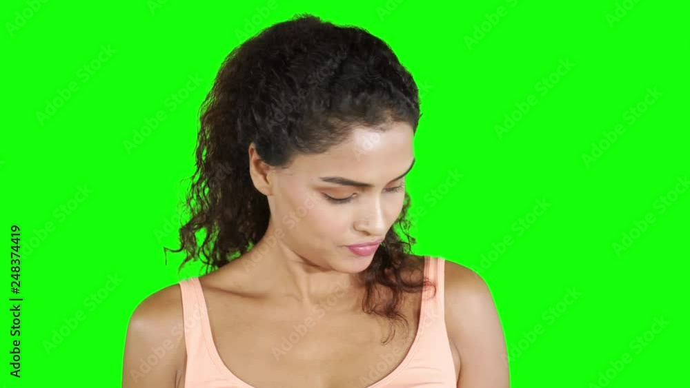 Attractive fitness woman exercising with dumbbells. Shot in 4k resolution with green screen background Attractive fitness woman exercising with dumbbells. Shot in 4k resolution with green screen background