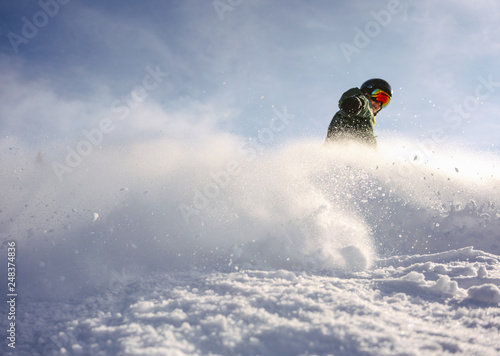 Snowboarder rides through the camera. Snow explosion © Piotr Golemo