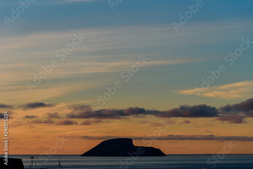 sunrise in azores  view of a small isalnd in front of angra do heroismo during sunrise. azores  portugal