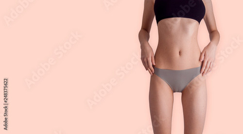 Beautiful girl in underwear posing on bright background photo