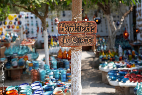 Handmade in Crete sign on a board attached to a pole.