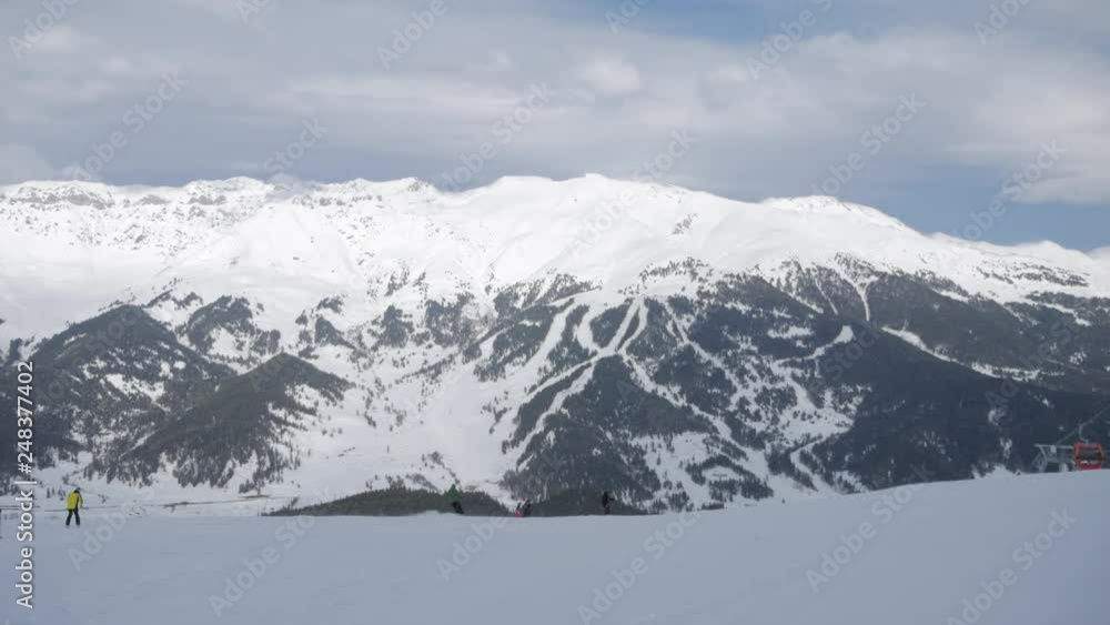 Skier skiing and people on snowboards ride down the slope on ski resort in mountains winter. Skier skiing and people on snowboards ride down the slope on ski resort in mountains winter.